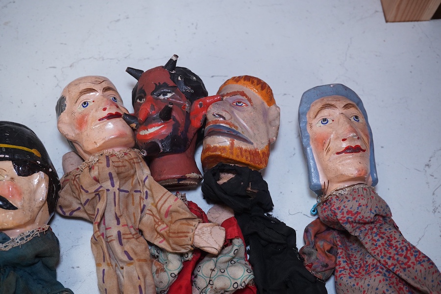 Eight early 20th century puppets, comprising of carved wooden heads, lower legs and feet, and held together by fabric clothes, characters include the devil, a skeleton, Austrian soldier, a clown, Mr. Punch, etc. approx 3